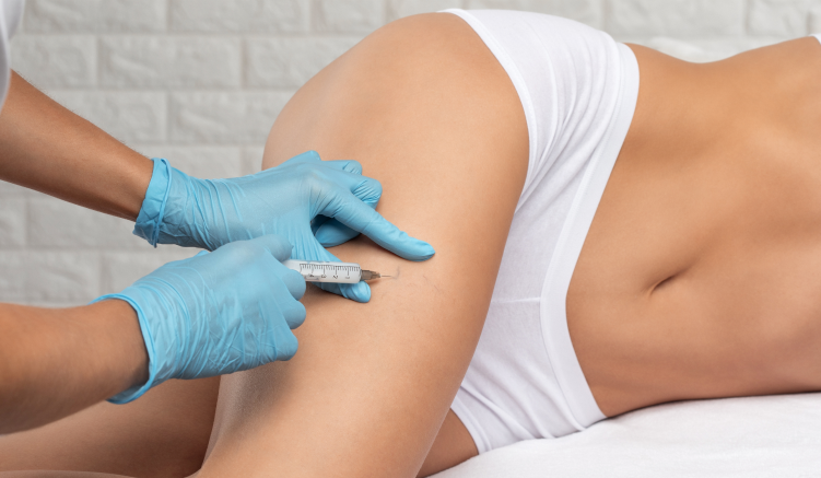 a professional applying a sclerotherapy injection to a woman's leg